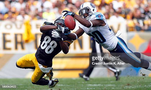 Alterraun Verner of the Tennessee Titans intercepts a pass intended for Emmanuel Sanders of the Pittsburgh Steelers in the first half during the game...