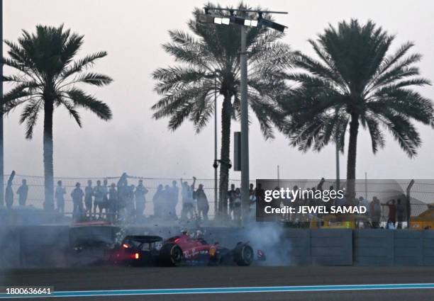 Ferrari's Spanish driver Carlos Sainz Jr crashes into the wall during the second practice session for the Abu Dhabi Formula One Grand Prix at the Yas...