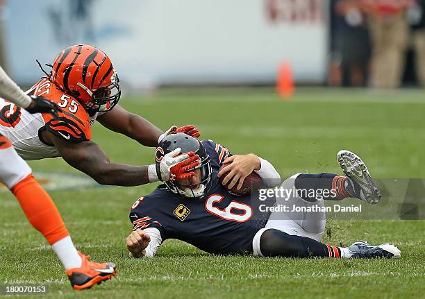 Sliding after running 18 yards for a first down, Jay Cutler of the Chicago Bears is grabbed by the head by Vontaze Burfict of the Cincinnati Bengals...