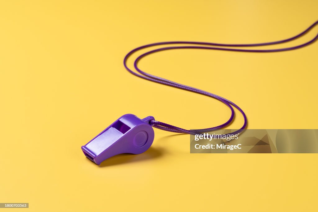 Purple Whistle With Lanyard on Yellow Background