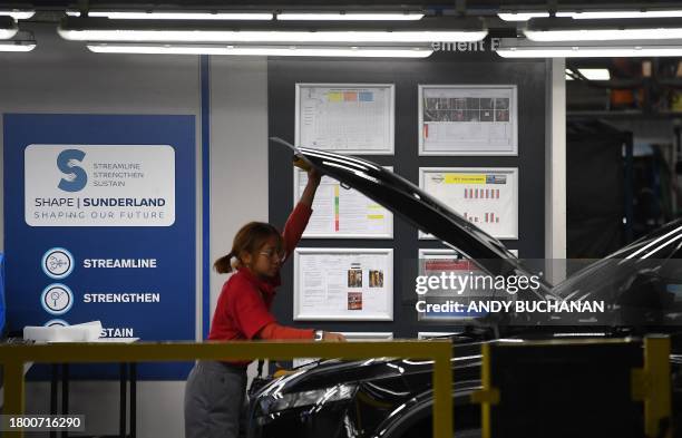 Worker quality control checks a newly manufactured Nissan Qashqai on the production line at the Nissan factory in Sunderland, north east England on...