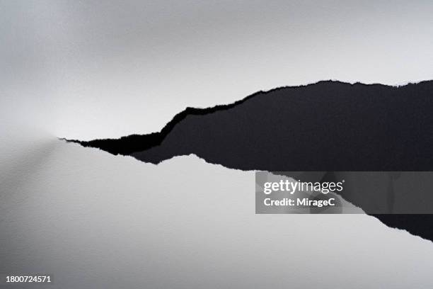 torn white paper on black - halved stock pictures, royalty-free photos & images