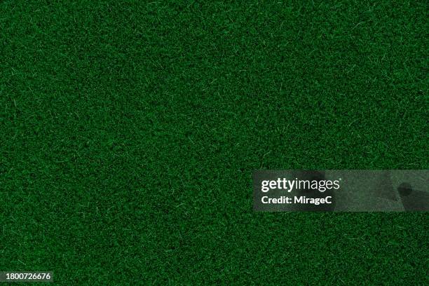 emerald green colored turf texture background, artificial grass - kunstgras stockfoto's en -beelden