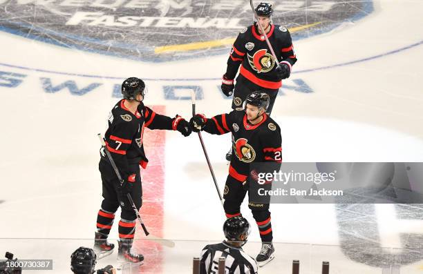 Erik Brannstrom of the Ottawa Senators celebrates his goal with teammate Brady Tkachuk during the third period the 2023 NHL Global Series in Sweden...