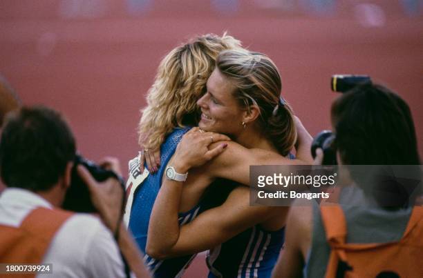 German athlete Heike Drechsler embraces German athlete Katrin Krabbe, both competing for East Germany, after the women's 200m final of the 1990...