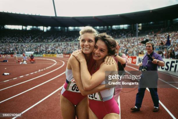 German athlete Katrin Krabbe embraces German athlete Grit Breuer at the 1991 German Athletics Championships, held at the Niedersachsenstadion in...