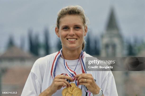 German athlete Katrin Krabbe poses with the three gold medals won at the 1990 European Athletics Championships, 1990. Krabbe won the medals in the...