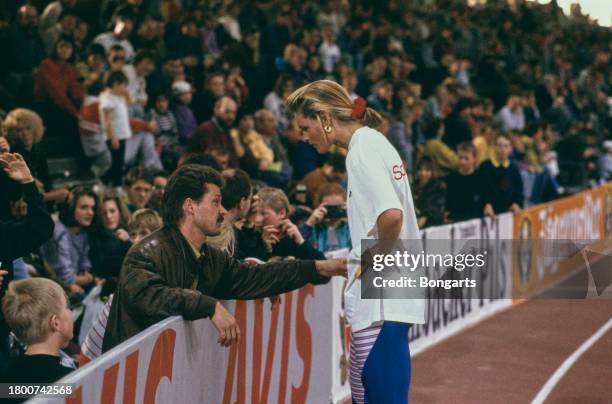 German athletics coach Thomas Springstein in conversation with German athlete Katrin Krabbe at the 1992 German Indoor Athletics Championships, held...