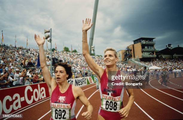 German athlete Grit Breuer and German athlete Katrin Krabbe waving to spectators at the 1991 German Athletics Championships, held at the...