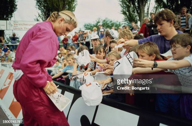 German athlete Katrin Krabbe signs autographs for young fans at the 1991 European Cup meeting, held at the Waldstadion in Frankfurt, Germany, June...