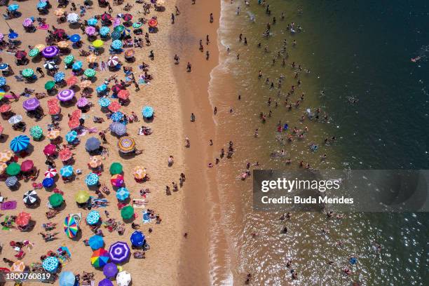 Aerial view of people enjoying the beach amid a record heat wave at Praia Vermelha Beach on November 18, 2023 in Rio de Janeiro, Brazil. A...