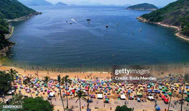 Aerial view of people enjoying the beach amid a record heat wave at Praia Vermelha Beach on November 18, 2023 in Rio de Janeiro, Brazil. A...