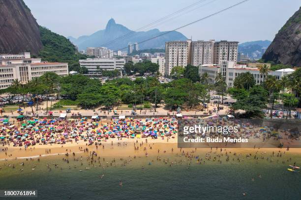 Aerial view of people enjoying the beach amid a record heat wave at Praia Vermelha Beach on November 18, 2023 in Rio de Janeiro, Brazil. A...