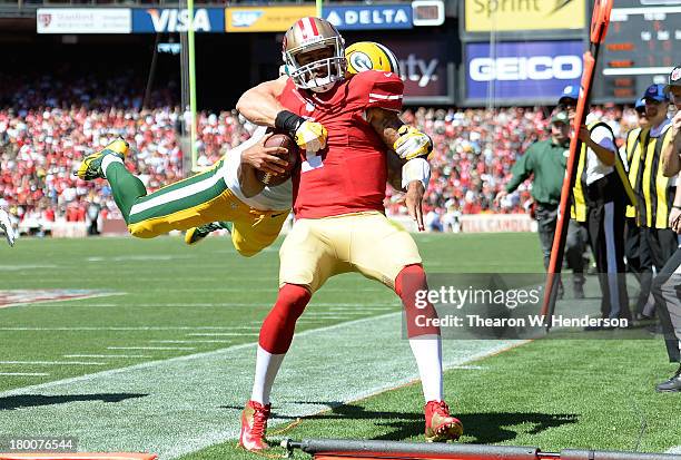 Clay Matthews of the Green Bay Packes tackles Colin Kaepernick of the San Francisco 49ers late out of bounds during the second quarter at Candlestick...