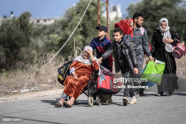 Displaced Palestinians walk along the Salah al-Din road towards a safe zone in the southern Gaza Strip, on Monday, Nov. 20, 2023. Fighting in the...