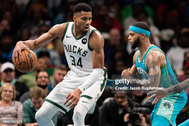 Miles Bridges of the Charlotte Hornets guards Giannis Antetokounmpo of the Milwaukee Bucks during an NBA In-Season Tournament game at Spectrum Center...