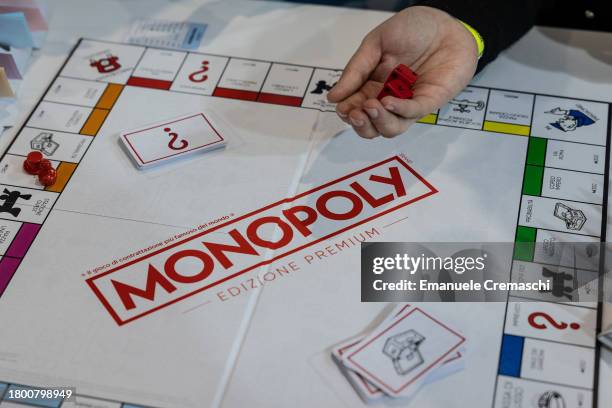 Woman holds a couple of dices while playing Monopoly during the "Entraingioco" Festival at Superstudio Maxi on November 18, 2023 in Milan, Italy....