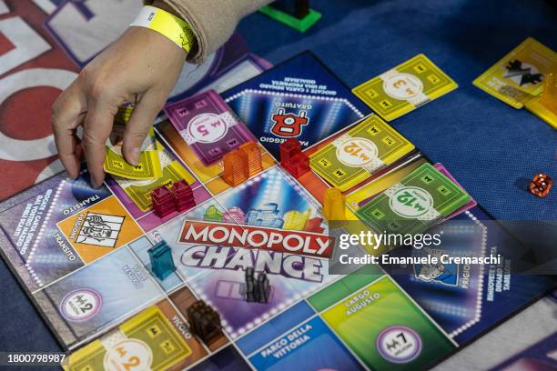 Woman holds a card while playing Monopoly Chance during the "Entraingioco" Festival at Superstudio Maxi on November 18, 2023 in Milan, Italy....