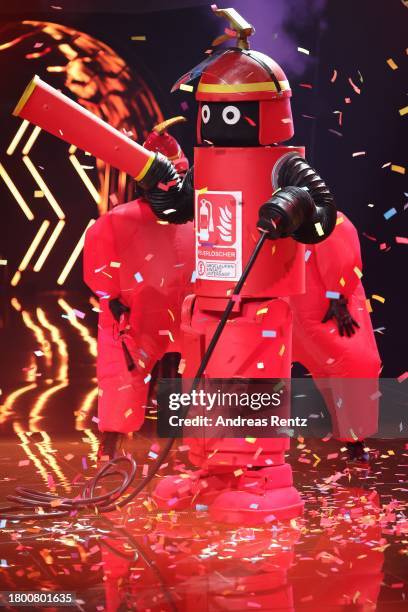 Der Feuerlöscher" performs on stage during the first showing of season 9 of "The Masked Singer" on November 18, 2023 in Cologne, Germany.