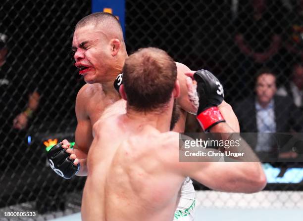 Trey Ogden punches Nikolas Motta of Brazil in a lightweight fight during the UFC Fight Night event at UFC APEX on November 18, 2023 in Las Vegas,...