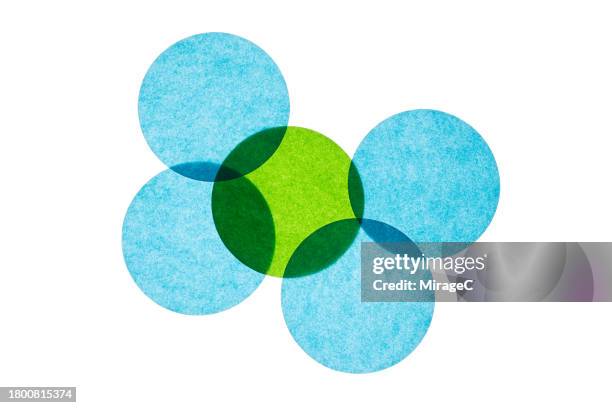 overlapping green and blue circular paper - interlocking circle stock pictures, royalty-free photos & images