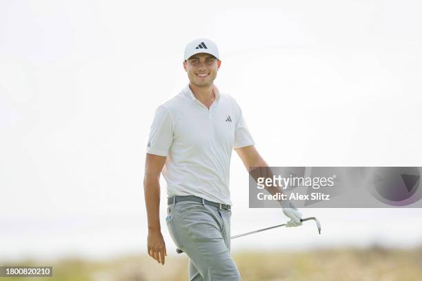 Ludvig Aberg of Sweden reacts to a chip in on the 14th green during the third round of The RSM Classic on the Seaside Course at Sea Island Resort on...