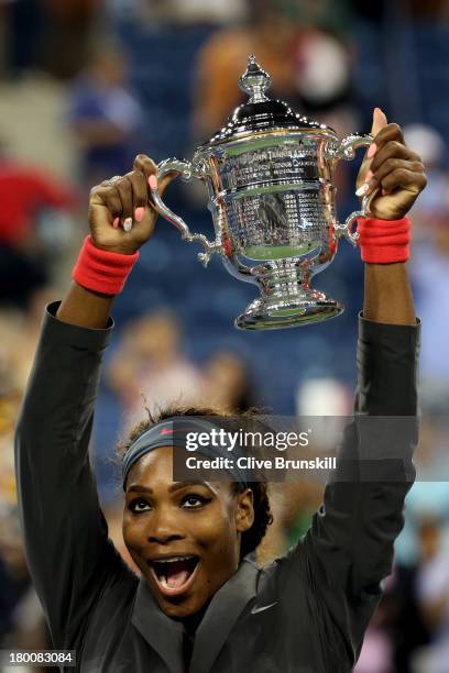 Serena Williams of the United States of America poses with the trophy after winning her women's singles final match against Victoria Azarenka of...