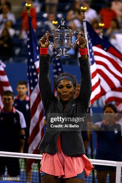 Serena Williams of the United States of America poses with the trophy after winning her women's singles final match against Victoria Azarenka of...