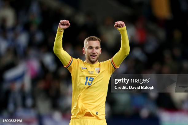 Denis Dragus of Romania celebrates as George Puscas of Romania scores the team's first goal during the UEFA EURO 2024 European qualifier match...