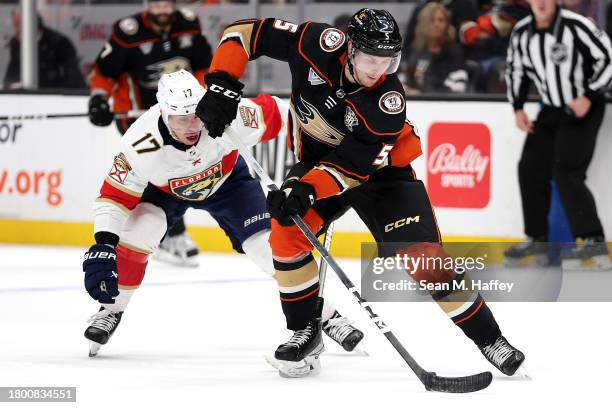 Urho Vaakanainen of the Anaheim Ducks controls the puck past the defense of Evan Rodrigues of the Florida Panthers during the first period of a game...