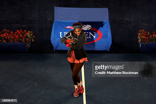 Serena Williams of the United States of America smiles as she poses with the trophy after winning her women's singles final match against Victoria...