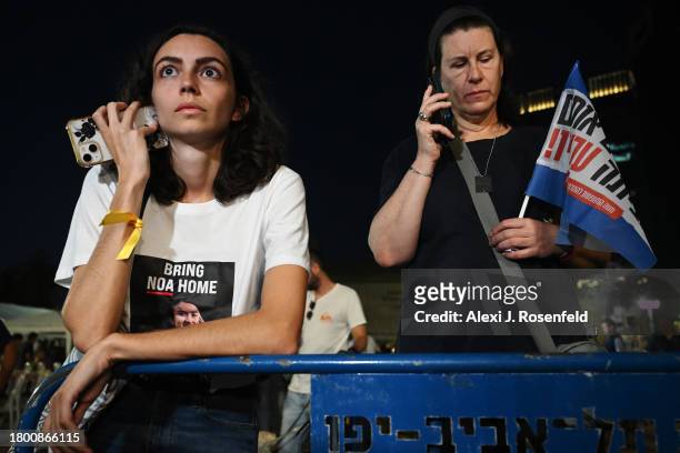 Families of the hostages and others watch the news broadcasts as hostages are released into Egypt before being brought into Israel by the ICRC,...