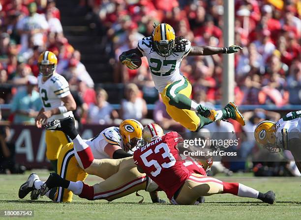 Running back Eddie Lacy of the Green Bay Packers leaps over NaVorro Bowman of the San Francisco 49ers in the fourth quarter at Candlestick Park on...