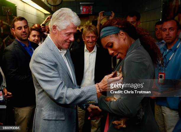 Former President Bill Clinton congratulates Serena Williams of the United States after her women's singles final victory on Day Fourteen of the 2013...