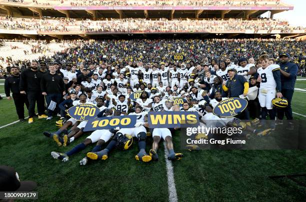 The Michigan Wolverines celebrate the 1000th win in program history after a 31-24 victory against the Maryland Terrapins at SECU Stadium on November...