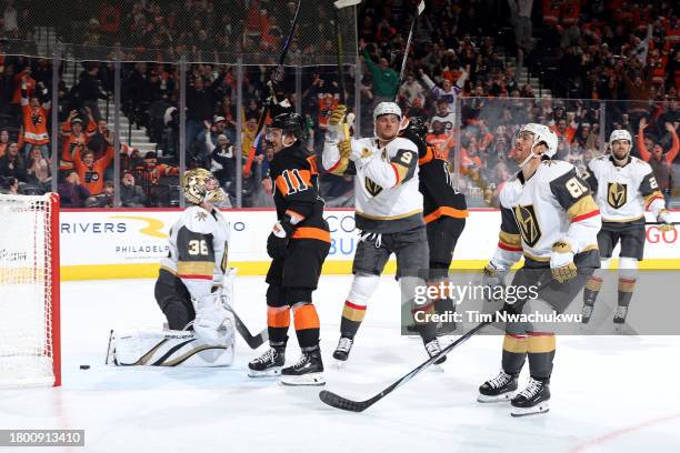 Travis Konecny and Sean Couturier of the Philadelphia Flyers react among the Vegas Golden Knights after Couturier scores the game-winning goal in...