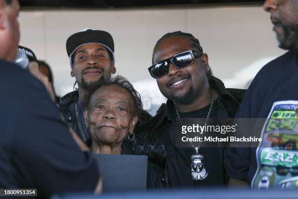 Compton , CA Kathie Wright and Eric Wright Jr. Listen as DJ Yella, left, gives a speech during a ceremony honoring Eazy-E with his own street named...