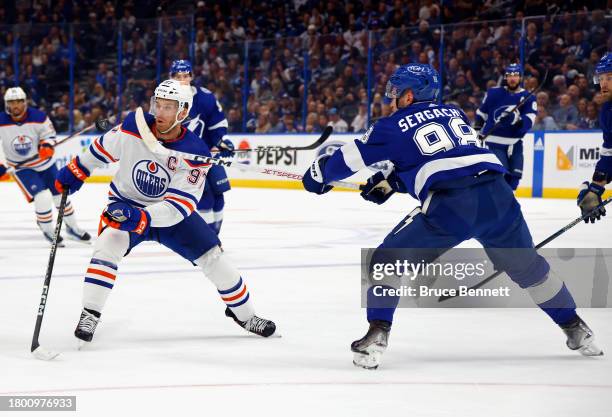 Mikhail Sergachev of the Tampa Bay Lightning is called for highsticking Connor McDavid of the Edmonton Oilers d1pat Amalie Arena on November 18, 2023...