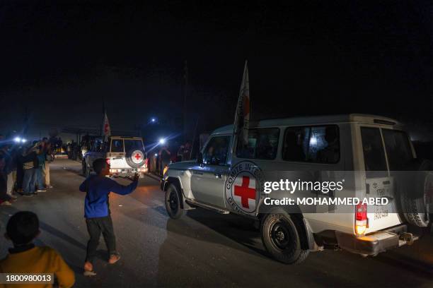 International Red Cross vehicles reportedly carrying hostages released by Hamas cross the Rafah border point in Gaza on the way to Egypt from which...