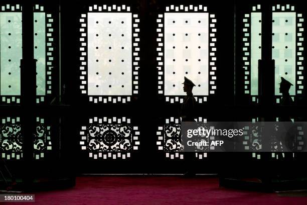 Chinese soldiers guard inside the gate of the Chinese Defense Ministry's Bayi Building while James Miller, US under secretary of defense for policy,...