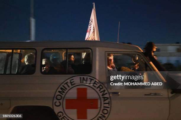 An International Red Cross vehicle reportedly carrying hostages released by Hamas crosses the Rafah border point in the Gaza Strip towards Egypt from...