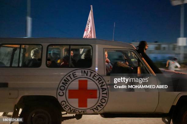 An International Red Cross vehicle reportedly carrying hostages released by Hamas crosses the Rafah border point in the Gaza Strip towards Egypt from...
