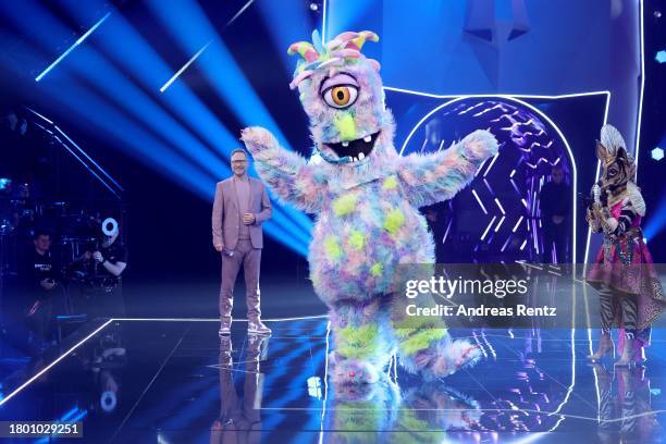 Matthias Opdenhövel, "Das Okapi" and "Der Lulatsch" are seen on stage during the first showing of season 9 of "The Masked Singer" on November 18,...