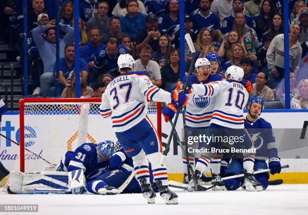 Derek Ryan of the Edmonton Oilers celebrates his 2nd goal of the game against the Tampa Bay Lightning during the second period and is joined by James...