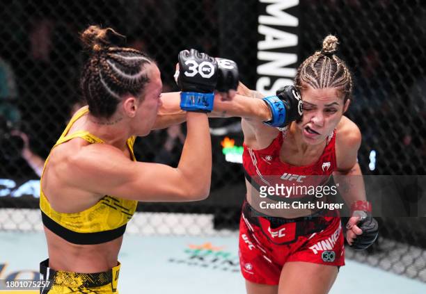 Amanda Ribas of Brazil punches Luana Pinheiro of Brazil in a strawweight fight during the UFC Fight Night event at UFC APEX on November 18, 2023 in...
