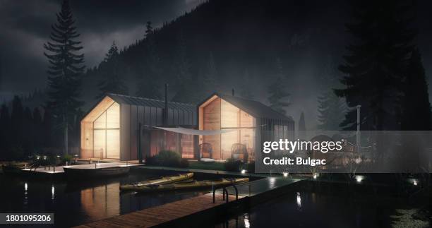 serene lakeside cabins at night - log cabin stock pictures, royalty-free photos & images
