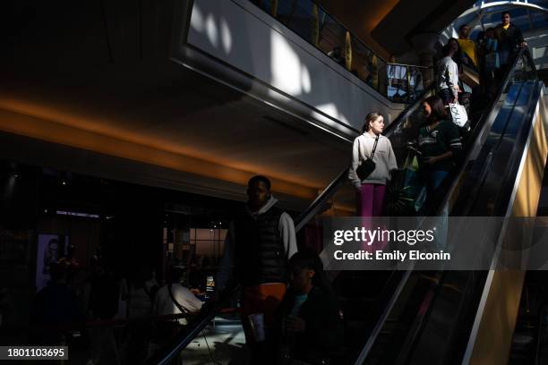 Shoppers ride down an escalator at Somerset Mall on November 24, 2023 in Troy, Michigan. The National Retail Federation projects that an estimated...