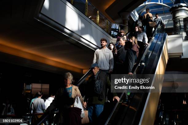 Shoppers ride down an escalator at Somerset Mall on November 24, 2023 in Troy, Michigan. The National Retail Federation projects that an estimated...