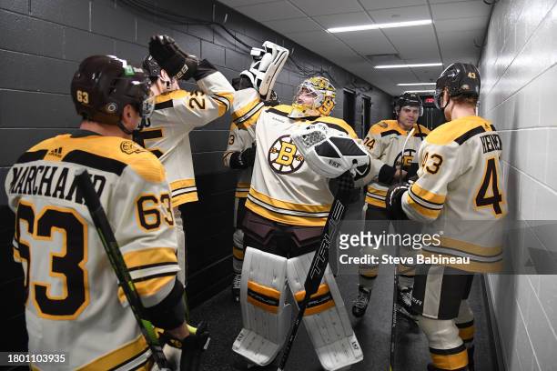 Brandon Carlo and Jeremy Swayman of the Boston Bruins high five before the game against the Detroit Red Wings on November 24, 2023 at the TD Garden...