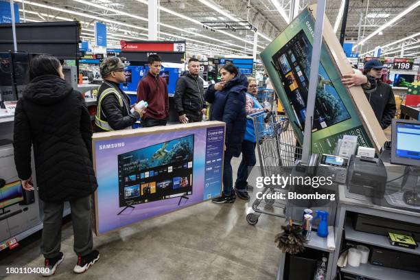 Shoppers purchase televisions at a Walmart store on Black Friday in Secaucus, New Jersey, US, on Friday, Nov. 24, 2023. An estimated 182 million...